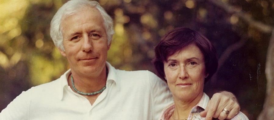 Barbara "Bobby" Neils Street (right) and her husband Bill Street stand in front of a blurred tree background.