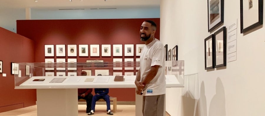 Photo of curator Khalil Kinsey in the Kinsey Collection gallery space.