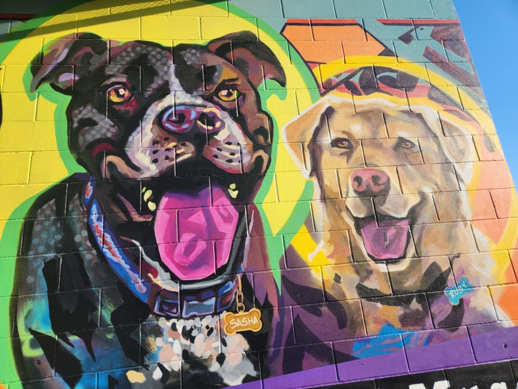 A spraypainted mural of two dogs 